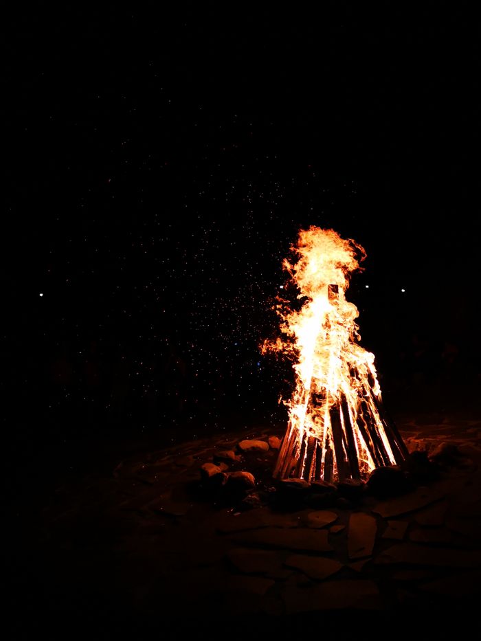 A captivating image of a bonfire burning brightly at night in Bran, Romania.